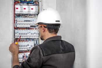 man-an-electrical-technician-working-in-a-switchboard-with-fuses-installation-and-connection-of-electrical-equipment (1)