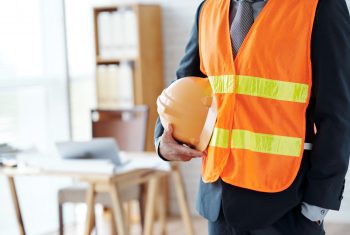 unrecognizable-male-construction-industry-executive-posing-in-safety-vest-with-hardhat (1)